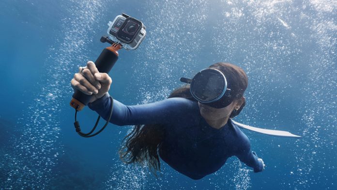 Insta360 Ace Pro 2 held underwater by free diver